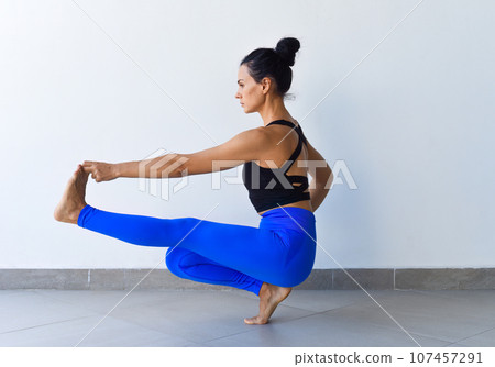 hand to big toe pose squat variation utthita hasta padangusthasana yoga with ukrainian woman making it indoors hand to big toe pose squat variation utthita hasta padangusthasana yoga with ukrainian woman making it indoors 107457291