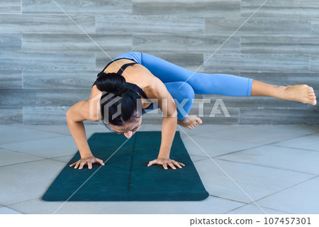 side crow pose variation  parsva bacasana yoga with ukrainian woman making it indoors 107457301