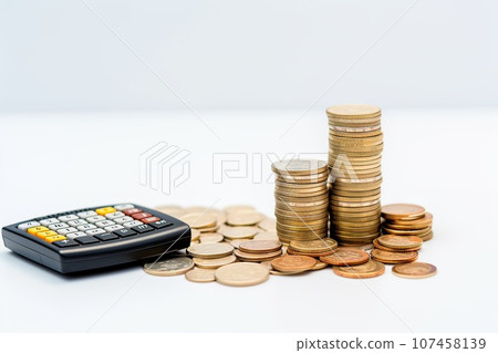 calculator and coins on white background, business and finance concept calculator and coins on white background, business and finance concept 107458139