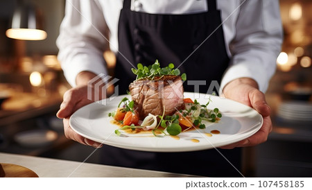 Chef holding plate with delicious roasted duck fillet on table in restaurant Chef holding plate with delicious roasted duck fillet on table in restaurant 107458185