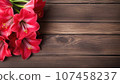 Pink lily flowers on wooden background. Top view with copy space 107458237