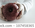 cute hand holding apple 107458365