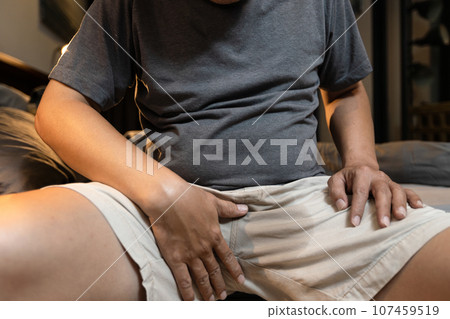 Stressed middle aged man with Premature Ejaculation,touching crotch,male reproductive fluid,semen or sperm wet his pants,Sexual Problems,premature ejaculation before sex,medical,checkup concept 107459519