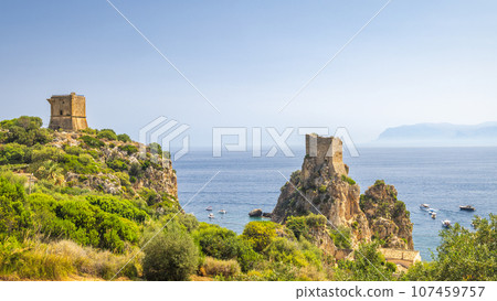 Watchtower with cliffs at The Faraglioni of Scopello rocky peaks Watchtower with cliffs at The Faraglioni of Scopello rocky peaks 107459757