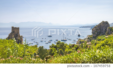 Watchtower with cliffs at The Faraglioni of Scopello rocky peaks 107459758