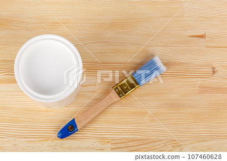 white paint with a brush on a wooden background with texture 107460628
