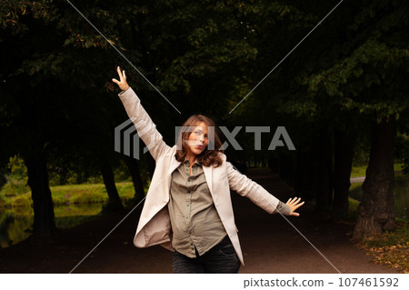 Attractive pregnant woman having fun outdoor in park Attractive pregnant woman having fun outdoor in park 107461592