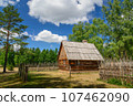 Beautiful traditional polish countryside and architecture, old house. Meadow with grass and roads near forest. 107462090