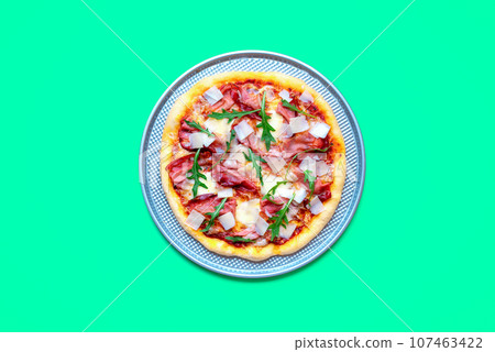 Homemade prosciutto pizza minimalist on a green table 107463422