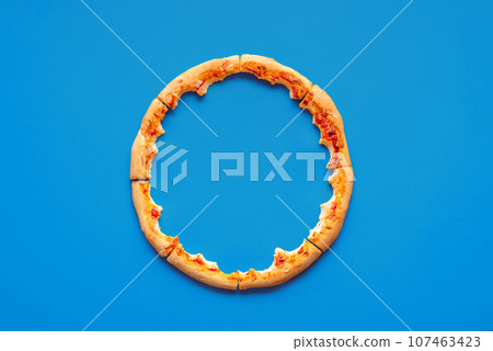 Pizza crust leftovers top view on a blue background Pizza crust leftovers top view on a blue background 107463423