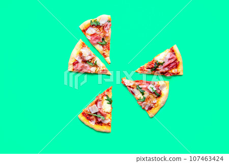 Pizza prosciutto slices minimalist on a green background Pizza prosciutto slices minimalist on a green background 107463424