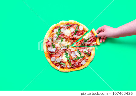 Prosciutto pizza above view, minimalist on a green background Prosciutto pizza above view, minimalist on a green background 107463426