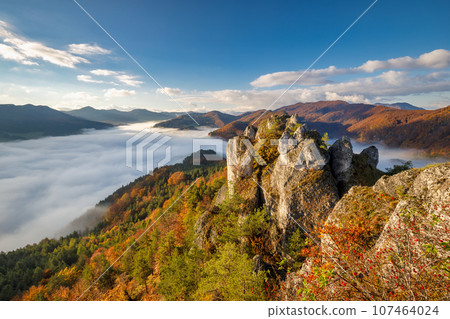 Scenic view of autumn mountain landscape with foggy valley. Scenic view of autumn mountain landscape with foggy valley. 107464024