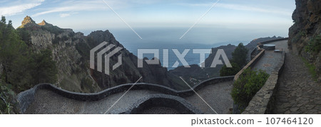 Panoramic view from viewpoint Mirador Ermita del Santo, Arure. View towards the valley of village Taguluche with small houses, sharp cliffs and atlantic ocean, La Gomera, Canary Islands, Spain 107464120