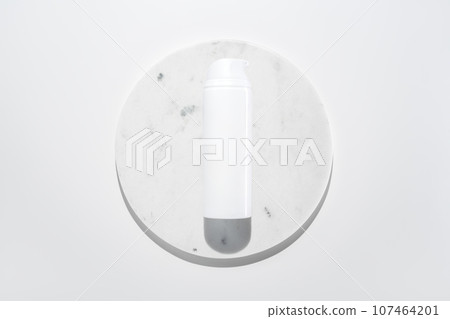 Face cleanser foam in light plastic bottle on marble circle white background. Clean minimalist high key skincare product shot top view Face cleanser foam in light plastic bottle on marble circle white background. Clean minimalist high key skincare product shot top view 107464201