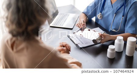 Doctor or physician recommend pill medical prescription to elderly female patient Doctor or physician recommend pill medical prescription to elderly female patient 107464924