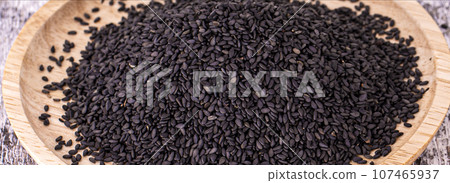 Close up of black rice on wooden surface 107465937