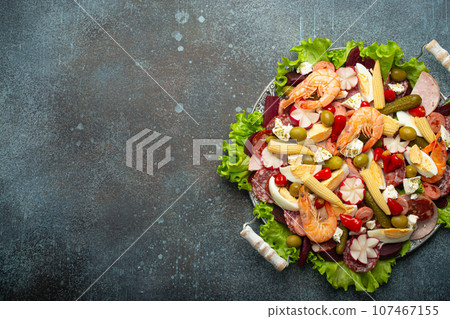 Close up of Fiambre, salad of Guatemala, Mexico and Latin America top view with cold cuts, shrimps, pickled vegetables. Festive dish for All Saints Day (Day Of The Dead) celebration, space for text Close up of Fiambre, salad of Guatemala, Mexico and Latin America top view with cold cuts, shrimps, pickled vegetables. Festive dish for All Saints Day (Day Of The Dead) celebration, space for text 107467155