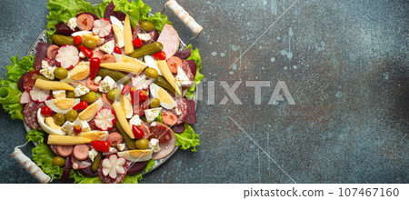 Close up of Fiambre, salad of Guatemala, Mexico and Latin America top view with cold cuts and pickled vegetables. Festive dish for All Saints Day (Day Of The Dead) celebration, space for text Close up of Fiambre, salad of Guatemala, Mexico and Latin America top view with cold cuts and pickled vegetables. Festive dish for All Saints Day (Day Of The Dead) celebration, space for text 107467160