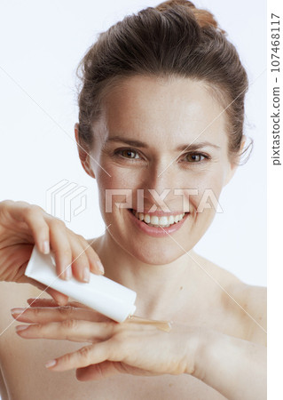 smiling modern woman with hand cream 107468117
