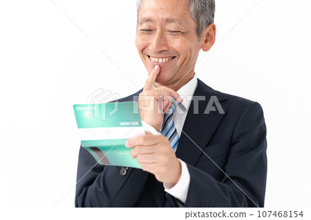 Man looking at passbook, smiling 107468154