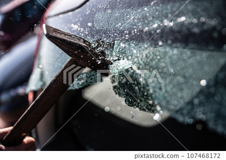 Car thief breaks the car window Car thief breaks the car window 107468172