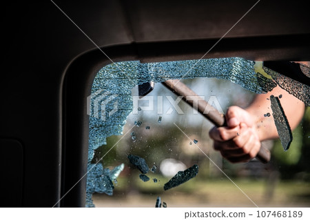 Car thief breaks the car window Car thief breaks the car window 107468189