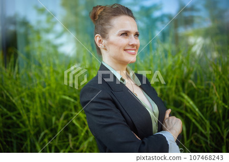 happy modern woman worker near business center in black jacket happy modern woman worker near business center in black jacket 107468243
