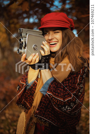 smiling modern 40 years old woman in red hat 107469211