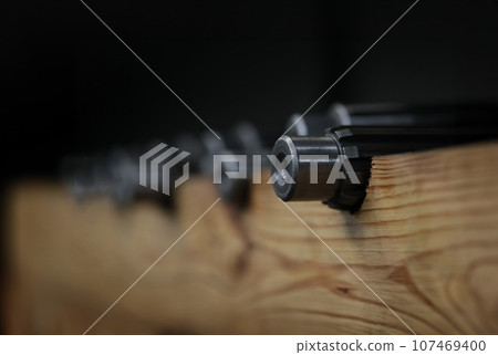 Industrial metal gear at factory. Prefabricated bearings of small diameter metal products and conveyor in production of gears Industrial metal gear at factory. Prefabricated bearings of small diameter metal products and conveyor in production of gears 107469400