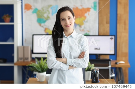 Casual business woman looks happy and smiling in office Casual business woman looks happy and smiling in office 107469445