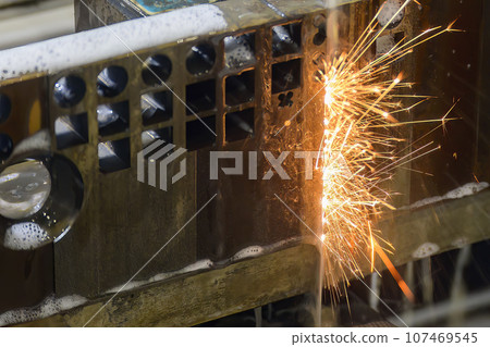 Closeup scene the wire EDM machine cutting the mold insert parts with the sparkling light. Closeup scene the wire EDM machine cutting the mold insert parts with the sparkling light. 107469545