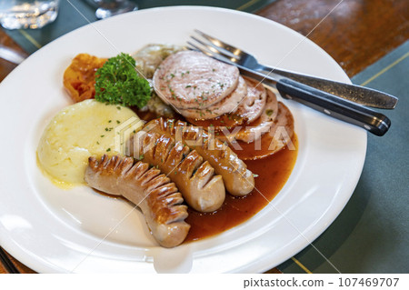 This German sausage dish is delicious. The outside is slightly crispy and the inside is soft and juicy. Mellow flavor with various spices and herbs. Alongside it are mashed potatoes that are smooth. This German sausage dish is delicious. The outside is slightly crispy and the inside is soft and juicy. Mellow flavor with various spices and herbs. Alongside it are mashed potatoes that are smooth. 107469707