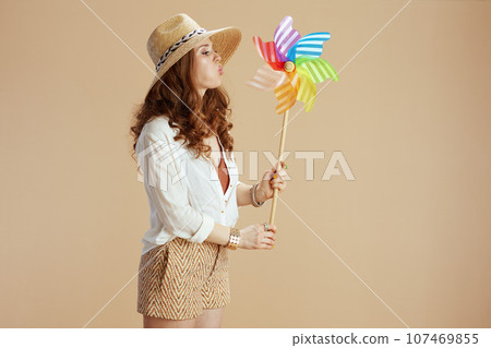 housewife in blouse and shorts isolated on beige 107469855