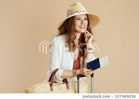 happy trendy woman in blouse and shorts isolated on beige 107469856