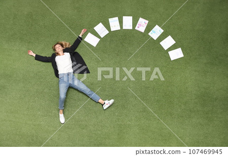 Woman is lying on green lawn along with chart business analytics 107469945