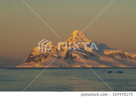 Lemaire strait coastal landscape, mountains and icebergs,  107470175