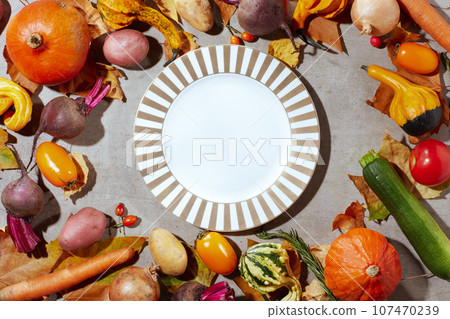 autumn flat lay on grey background with pumpkins 107470239