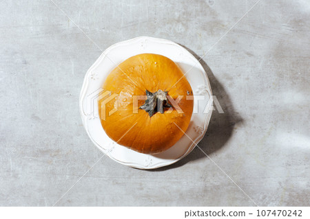 autumn flat lay on grey background with pumpkins 107470242
