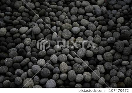 Black pebbles wallpaper texture closeup 107470472