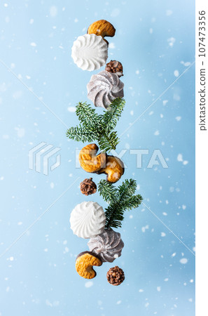 Levitation of sweets on a blue background Levitation of sweets on a blue background 107473356