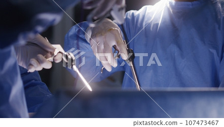 Close up of medics using laparoscopy instruments during surgery Close up of medics using laparoscopy instruments during surgery 107473467
