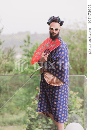 Young man wearing bathrobe night suit posing outdoor 107473601