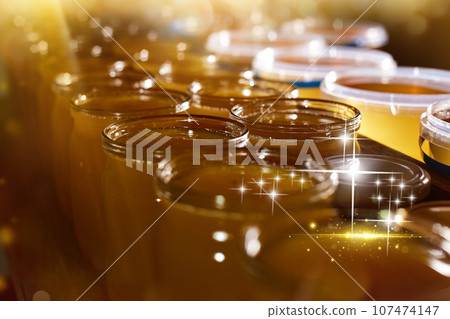 a jar of sweet honey in barrels are stored on a shelf in the pantry sweet food and delicious. High quality photo a jar of sweet honey in barrels are stored on a shelf in the pantry sweet food and delicious. High quality photo 107474147