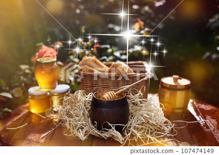 a jar of sweet honey with cheese and roses and fresh bread with bright light beautiful decoration creative photo in a bucket on a wooden table in the garden with flowers for breakfast delicious food a jar of sweet honey with cheese and roses and fresh bread with bright light beautiful decoration creative photo in a bucket on a wooden table in the garden with flowers for breakfast delicious food 107474149