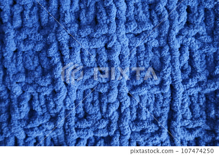 Dark blue handmade knitting blanket background. Dark blue handmade knitting blanket background. 107474250