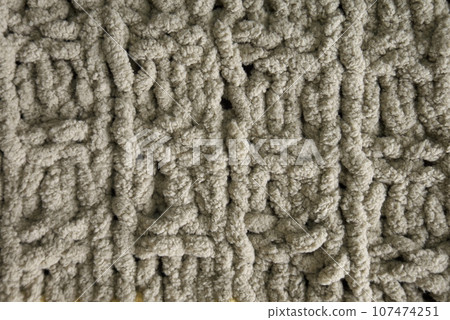 Dark brown handmade knitting blanket background. 107474251