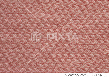 Light salmon pink handmade knitting blanket background. Light salmon pink handmade knitting blanket background. 107474255