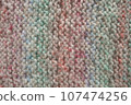 Light pastel colored stripy handmade knitting blanket background. 107474256