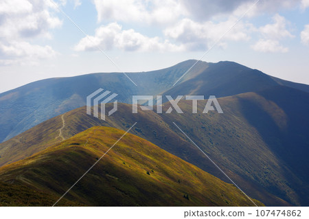 nature background with mountains. colorful scenery with hills and meadows on the steep slopes. sunny day in early autumn. ukraine 107474862